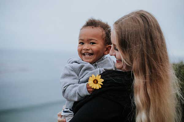 A cute kid with flower in a hand