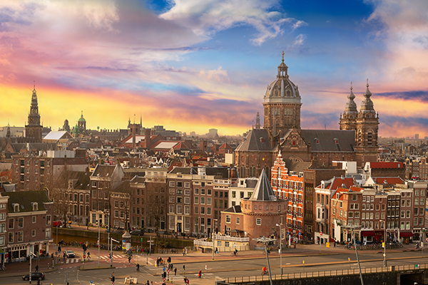 Amsterdam, Netherlands town cityscape over the Old Centre District with Basilica of Saint Nicholas at dusk.
